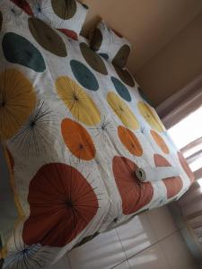 a pillow with umbrellas painted on it at The Grace quest house in Ngodini