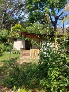 a small house with a fence in a yard at Anez Cabin'S in Cabuya