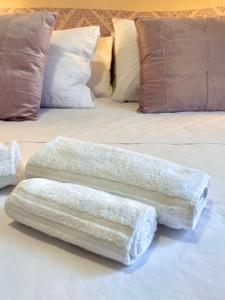 two pillows sitting on top of a bed at CASA GIULIA - Holiday Home in Olbia