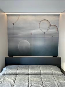 ein Schlafzimmer mit einem Bett mit zwei Ballons an der Wand in der Unterkunft Rondinella Suite in Lignano Sabbiadoro