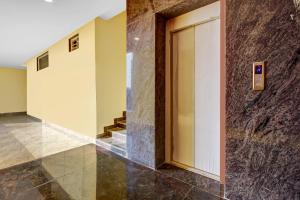 a hallway with a door in a building at Ab7 Residency Near Miraj Cinemas - Shalini Shivani in Hyderabad