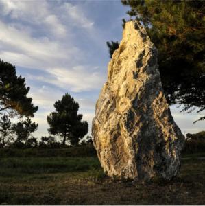 a large rock sitting in the middle of a field at Hôtel Restaurant Corto Maltese in Le Palais