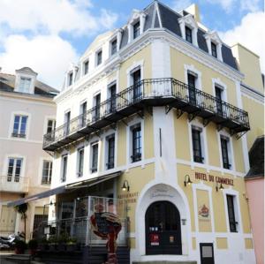 a yellow and white building with a balcony on it at Hôtel Restaurant Corto Maltese in Le Palais