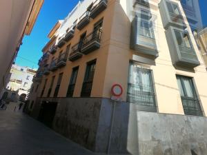 a building with a sign on the side of it at Modern 2 Bed Apartment in Historic Centre in Mutxamel