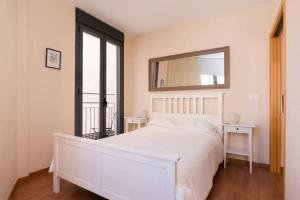 a white bedroom with a large bed and a mirror at Modern 2 Bed Apartment in Historic Centre in Mutxamel