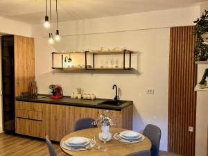 a dining room with a table and a kitchen at DD Apartments - Mavrovo in Mavrovo