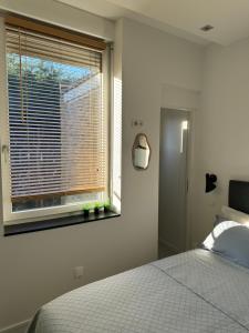 a bedroom with a bed and a window at Maison Belle Rade : La Balise in Malo-les-Bains