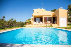 a villa with a swimming pool in front of a house at D05 - Amadeus Sunset Villa in Mato Porcas