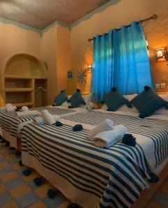 A bed or beds in a room at RIAD dar POUBLANC