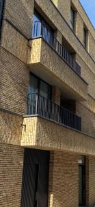 a brick building with balconies on the side of it at Central Studio in Kortrijk in Kortrijk