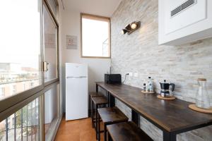 a kitchen with a wooden counter and a refrigerator at 59 Tourist House Bologna Lame - Self check-in in Bologna