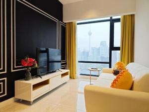 a living room with a couch and a television at Axon Bukit Bintang By moonlight in Kuala Lumpur