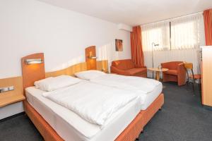Postel nebo postele na pokoji v ubytování Tespo Hotel und Sportpark