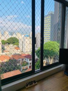 a view of a city from a window at Felicitatem Apartments Higienópolis - Apartamento Compartilhado in São Paulo