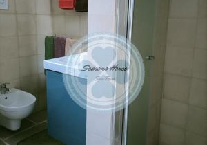 a bathroom with a shower with a sink and a toilet at Seasons Home San Foca in San Foca
