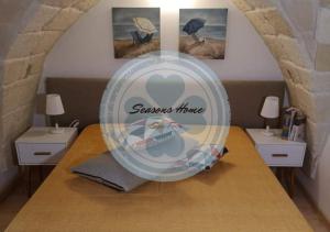 A bed or beds in a room at Seasons Home San Foca
