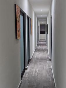 a hallway with white walls and a tile floor at The Blue Eco Lodge in Valladolid