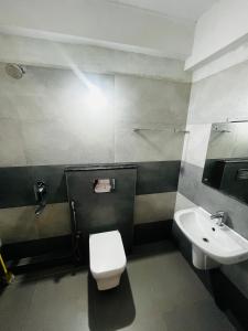 a bathroom with a toilet and a sink at REGAL SUITES in Trivandrum