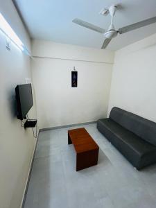 a living room with a couch and a coffee table at REGAL SUITES in Trivandrum