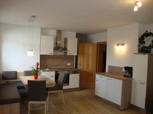 a kitchen and dining room with a table and chairs at Gruberbauer Remsach in Bad Gastein