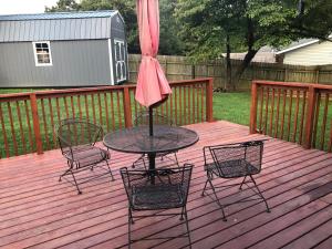 a patio with a table and chairs on a deck at Cozy&Quiet*Fenced backyard* 17 Mins UT MktSquare in Knoxville