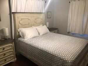 a bedroom with a bed with two pillows on it at Cozy&Quiet*Fenced backyard* 17 Mins UT MktSquare in Knoxville
