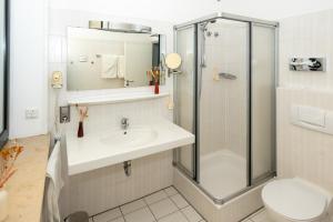 a bathroom with a sink and a shower at Tespo Hotel und Sportpark in Kaarst