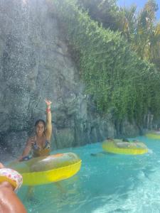 a woman riding on an inner tube in a swimming pool at Casa de colon in Los Silos
