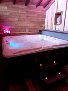 a large bath tub sitting in a room at Le Grand Chalet in La Chapelle
