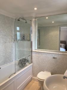 a bathroom with a shower and a toilet and a sink at Close to Kensington palace located double room in London