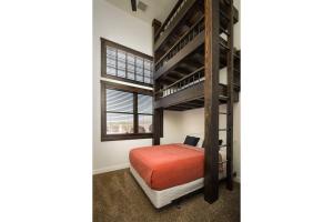 a bedroom with a bunk bed and a window at Unique Downtown Rental - La Dolce Vita Villas #5 in Moab