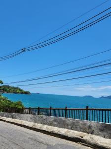 a view of the ocean from the side of a road at Casa temporada Ilhabela in Ilhabela