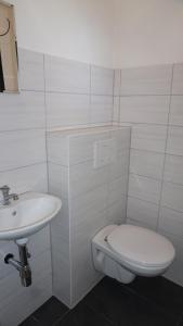 Baño blanco con aseo y lavamanos en Lechbruck am See Feriendorf Hochbergle Haus 23, en Lechbruck