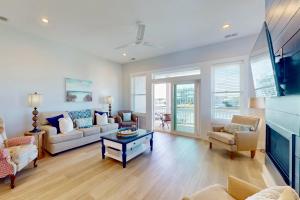 a living room with a couch and a table at Blue Oasis in Carolina Beach +42 photos