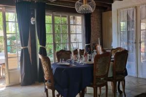 a dining room with a blue table and chairs at Maison Briadre Paris Disney gitelevouilly in Chauffry