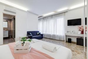 a living room with a bed and a tv at DIDAVI' Guest House in Rome