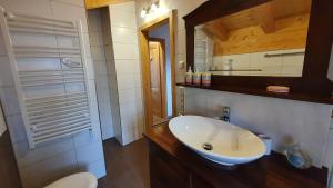 Lechbruck am See Feriendorf Via Claudia Haus 65 Casa Bavaria في ليتشبروك: حمام مع حوض أبيض ومرآة +31 صورة