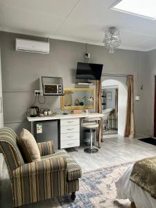 un soggiorno con scrivania e divano di Silken Trap Guest House NO LOADSHEDDING a Johannesburg