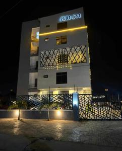 a building with a sign on it at night at The Seasons Apartment Kado in Abuja