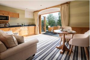 a kitchen and living room with a couch and a table at Yewfield Self Catering Apartments in Hawkshead