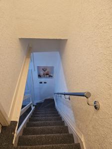 a staircase in a building with a stair railing at Your Happy Place-2 Bedroom House in Liverpool