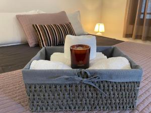 a basket with towels and a cup of coffee on a bed at The Manor 1926 in Colombo