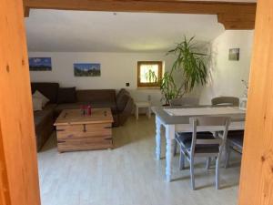 a living room with a couch and a table at Große schöne Mansardenwohnung mit 2 Balkonen in Lofer