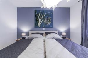 a bedroom with a bed with a painting on the wall at Oberhausen an der Nahe einfach nur schön in Oberhausen