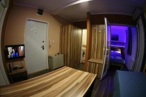 a room with a bed and a room with a tv at Apartments 43 in Krnjača
