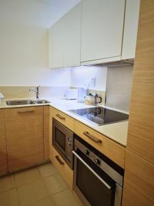 a kitchen with a sink and a stove at Wood studio flat in London