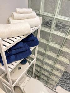 a towel rack with towels and a toilet in a bathroom at Nature View #2 in Fort Myers Beach