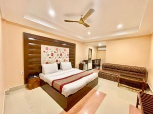 a bedroom with a bed and a ceiling fan at Hotel V-i sea view, puri private-beach-gym-spa fully-airconditioned-hotel lift-and-parking-facilities breakfast-included in Puri