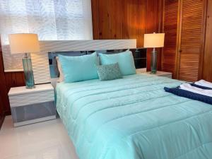 a large blue bed in a room with two lamps at Nature View #3 in Fort Myers Beach +32 photos