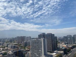 a city with tall buildings and a cloudy sky at Apartamento centro Santiago vacaciones trabajo in Santiago